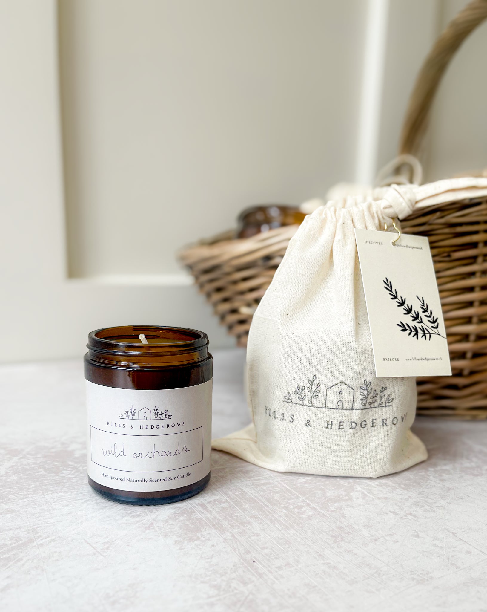 Wild Orchards natural soy wax candle, hand-poured sustainable luxury, perfect for relaxation and rejuvenation. In amber class jar with neutral label comes in cotton drawstring gift pouch.