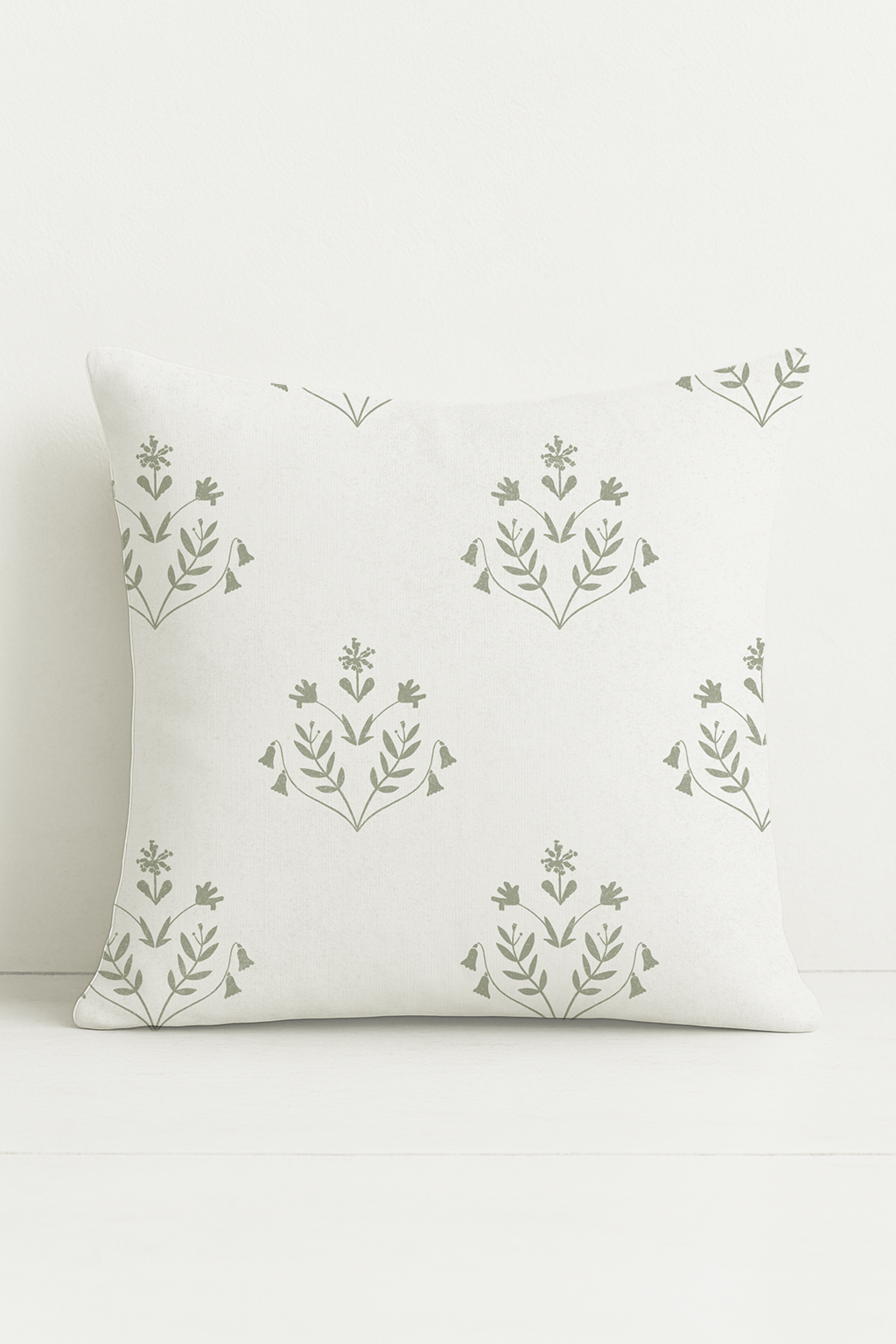 A soft green floral cushion with striped cotton-linen back. Inspired by garden stillness at dawn. Made to order in the UK.