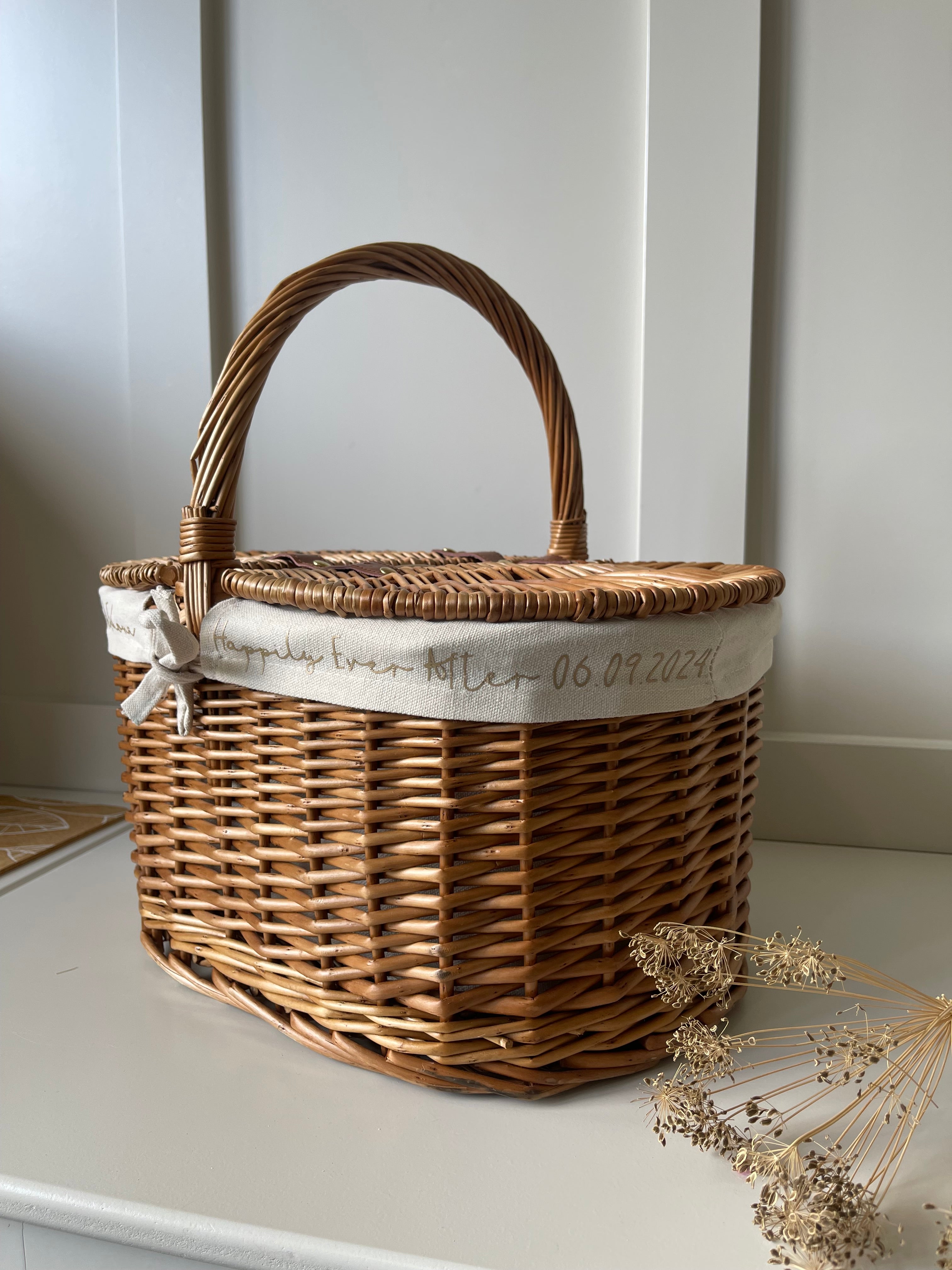 Personalised wicker wedding baskets for UK weddings, including flower girl baskets, gift hampers, and welcome baskets.