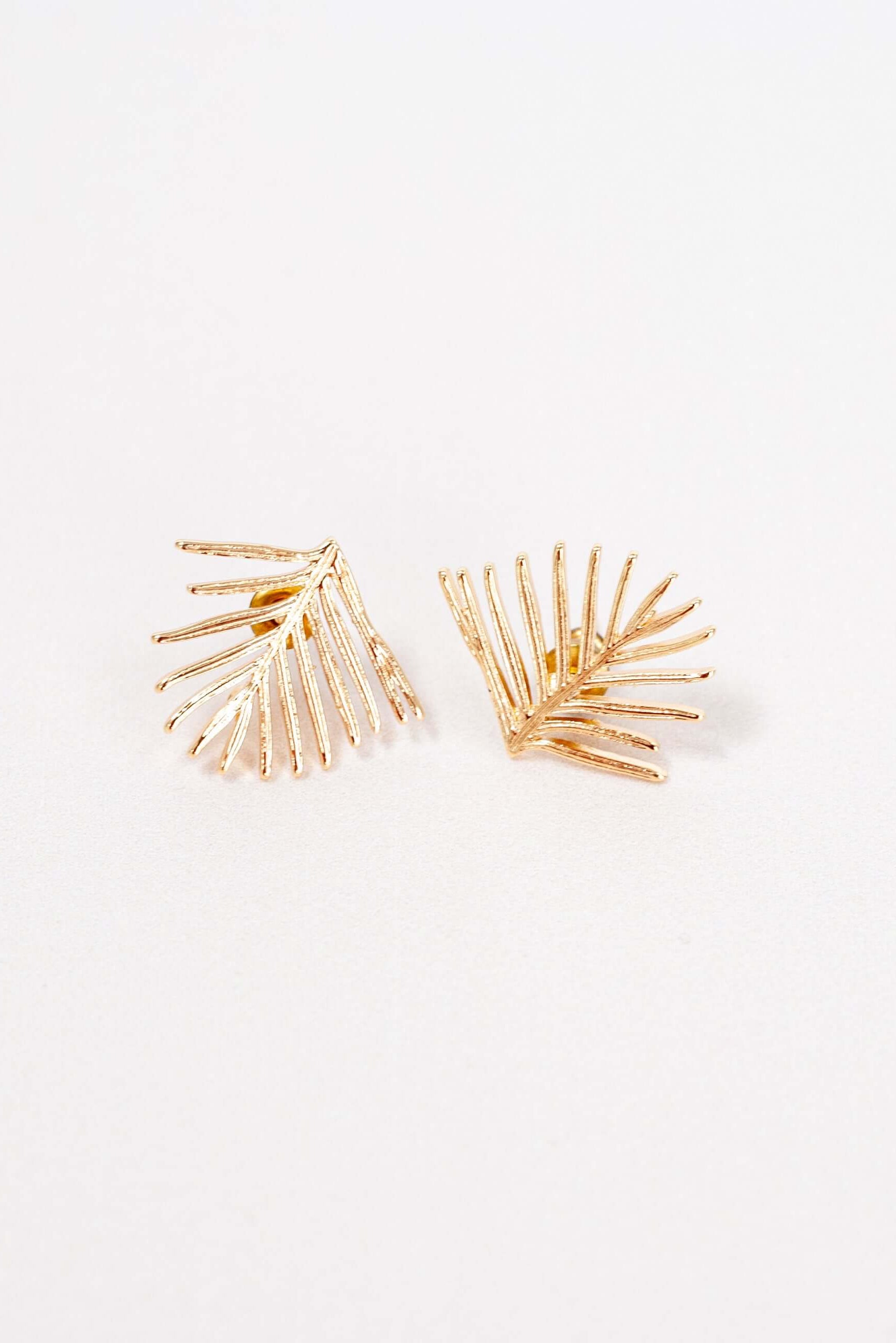 Handmade Evergreen Leaf Stud Earrings, gold-plated brass with a textured finish. Pine needle-inspired design, perfect for winter, gift-ready in a cotton pouch.