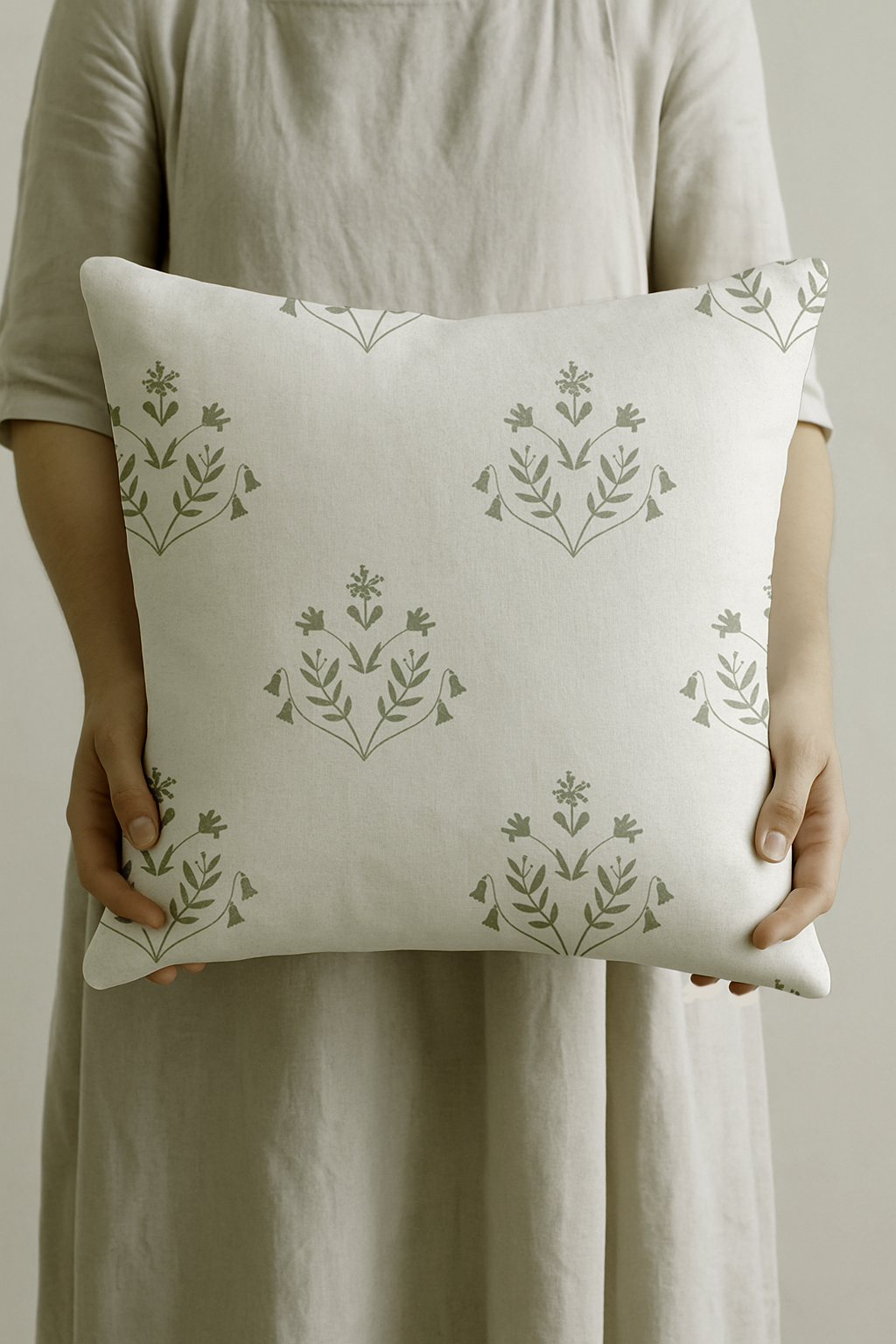 A soft green floral cushion with striped cotton-linen back. Inspired by garden stillness at dawn. Made to order in the UK.