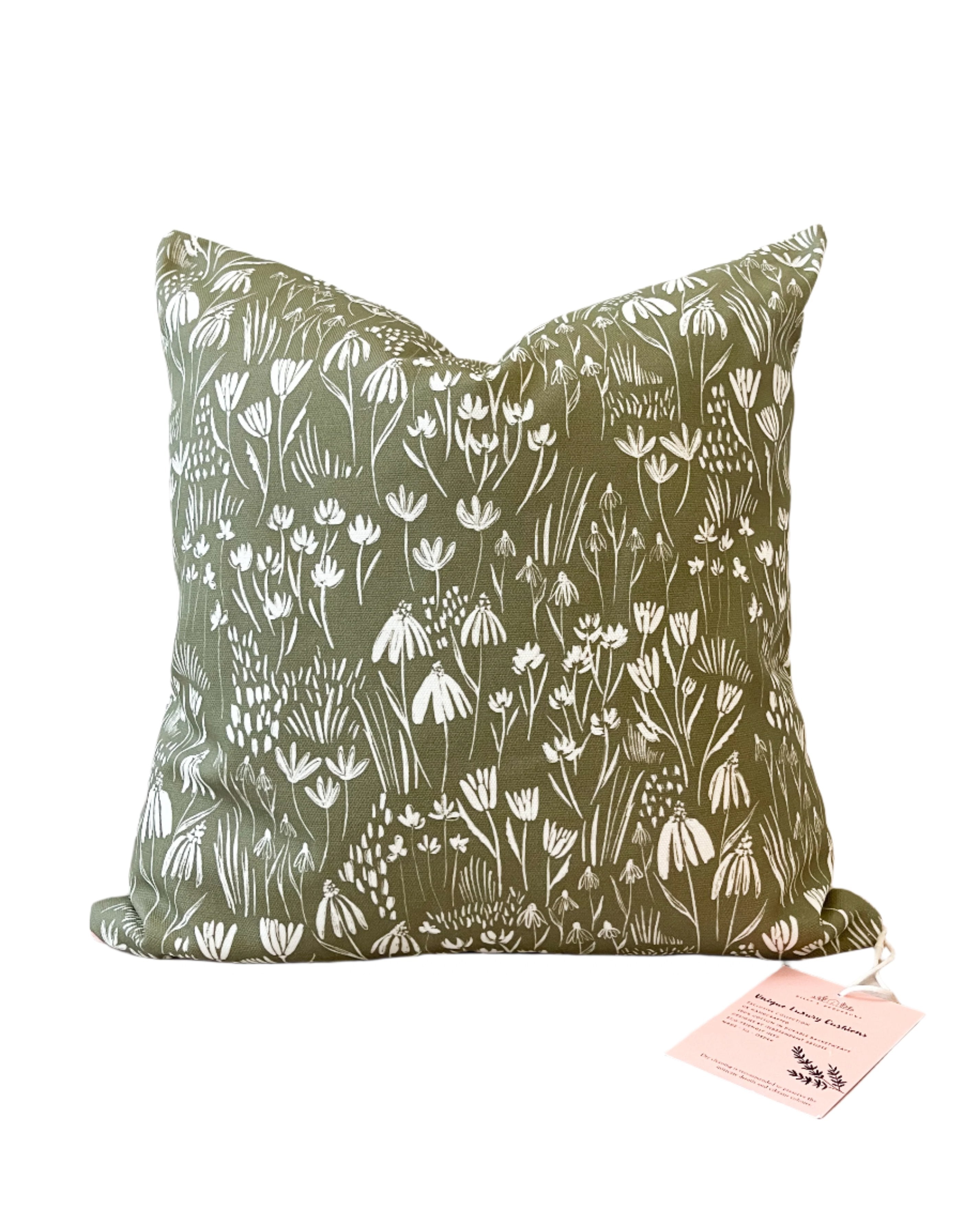 Botanical-inspired decorative cushion with lush green and floral patterns, handmade in the UK from sustainable basketweave cotton.