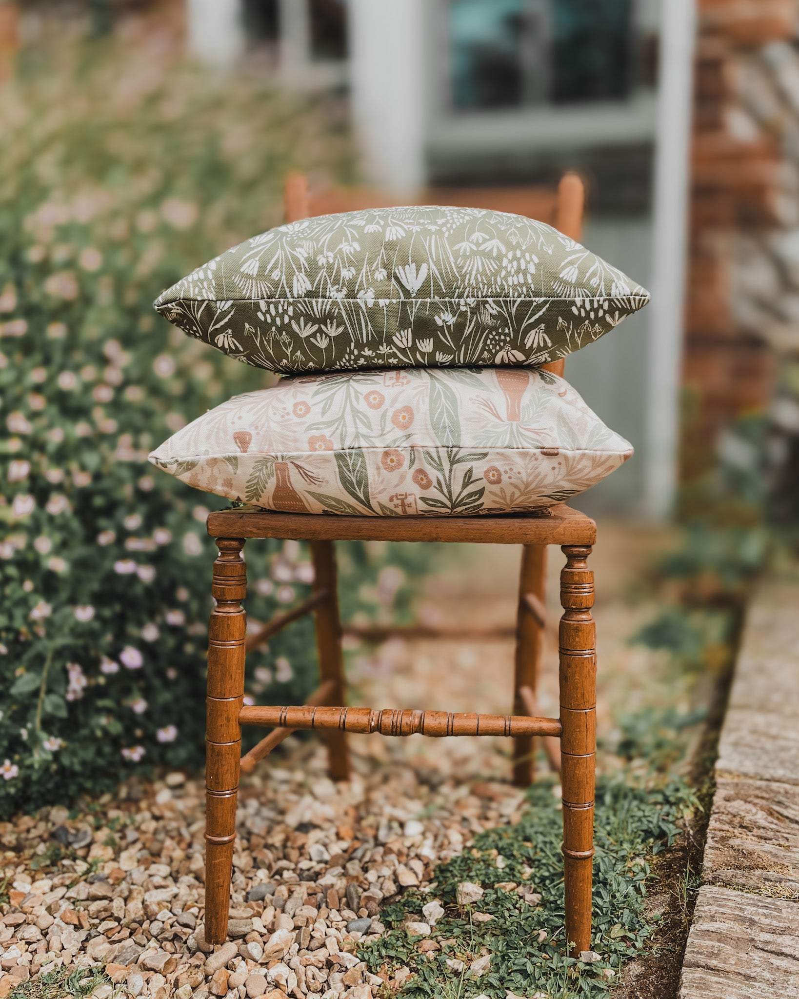 Accent Cushion with nature-inspired print outside on old wooden chair